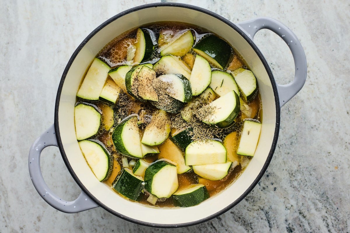 zucchini in large pot with broth and thyme.
