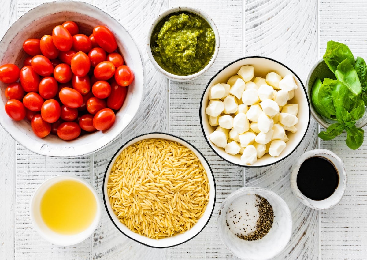 ingredients in bowls to make caprese orzo salad.