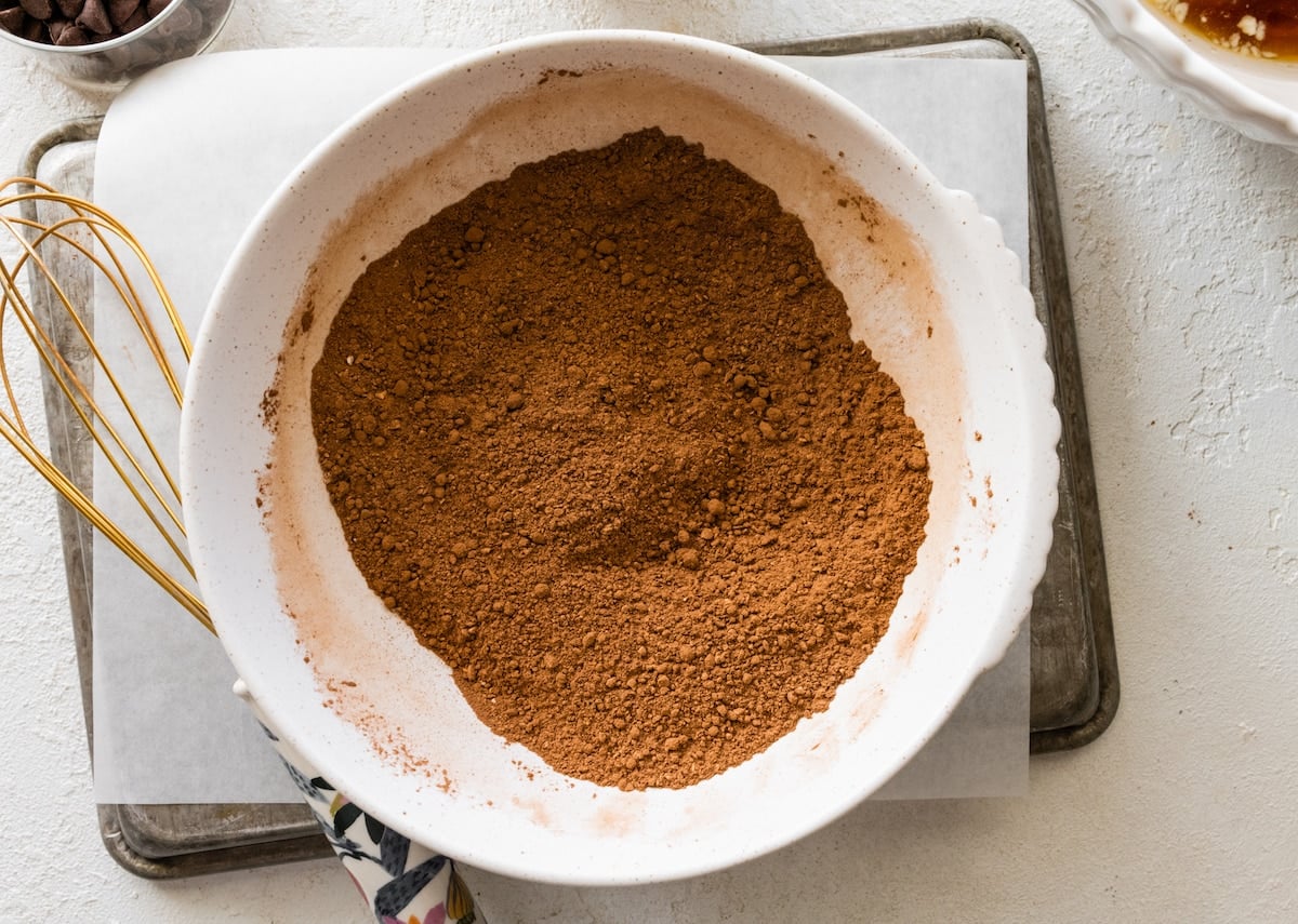 dry ingredients in mixing bowl with whisk to make chocolate zucchini cake.