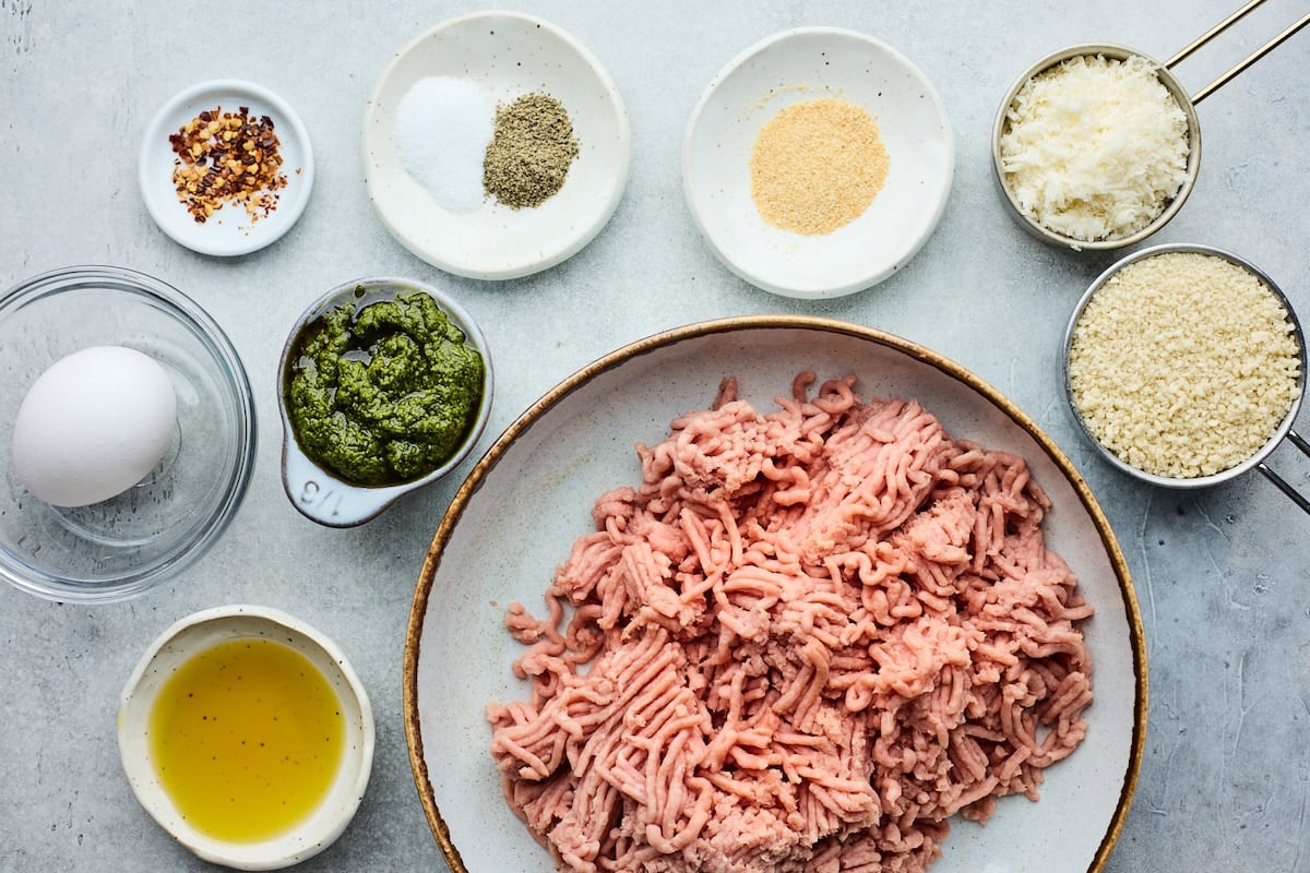 ingredients in bowls to make turkey pesto meatballs.