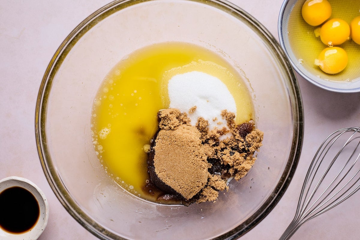 sugar and melted butter in mixing bowl to make raspberry brownies.