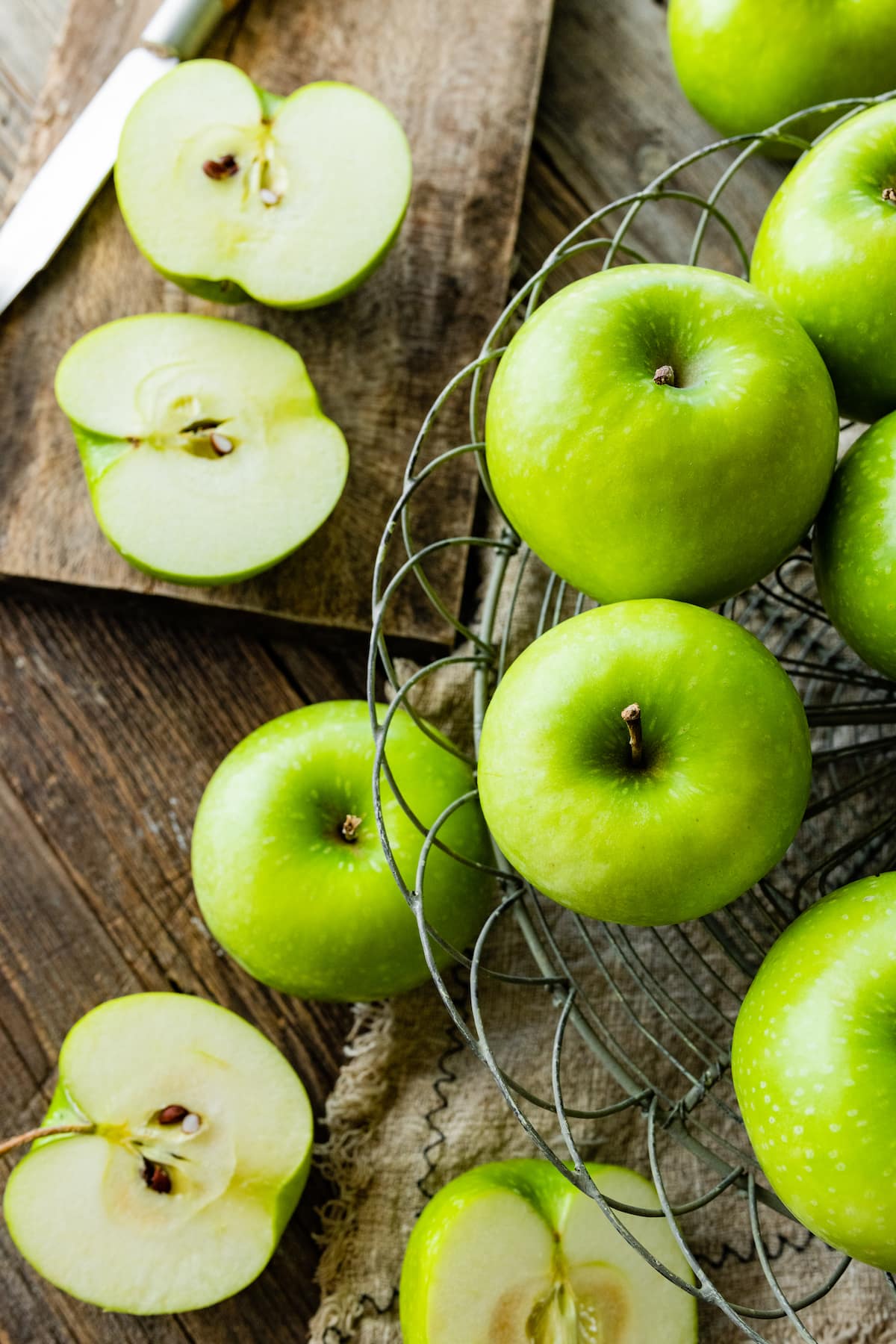 green apples on wood background.