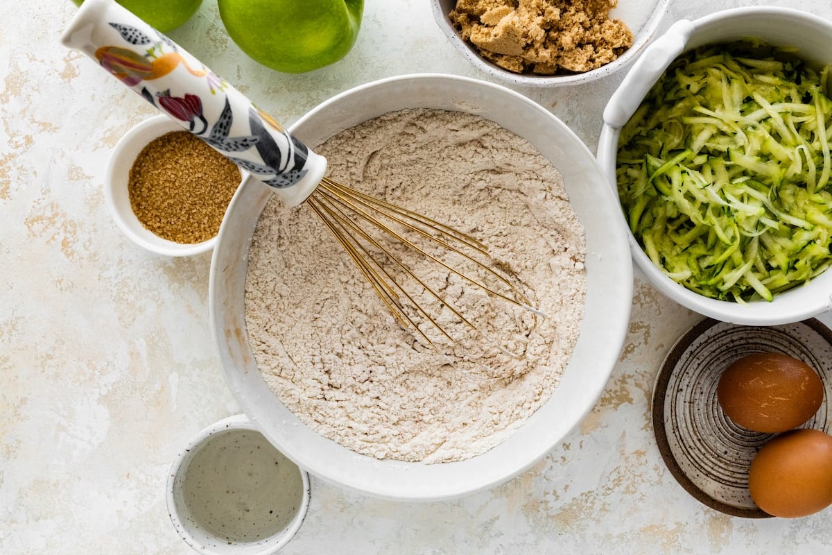 dry ingredients in mixing with bowl to make apple zucchini bread.