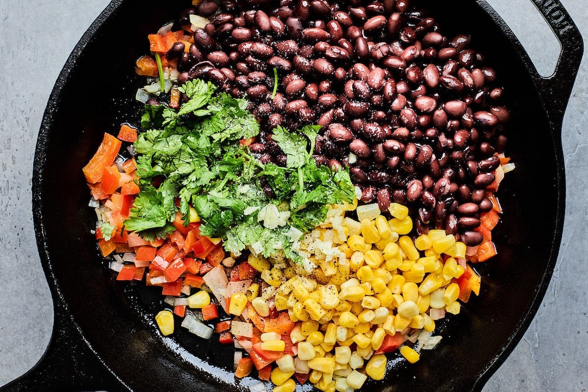 black beans, corn, red pepper, onion, and cilantro in cast iron skillet.
