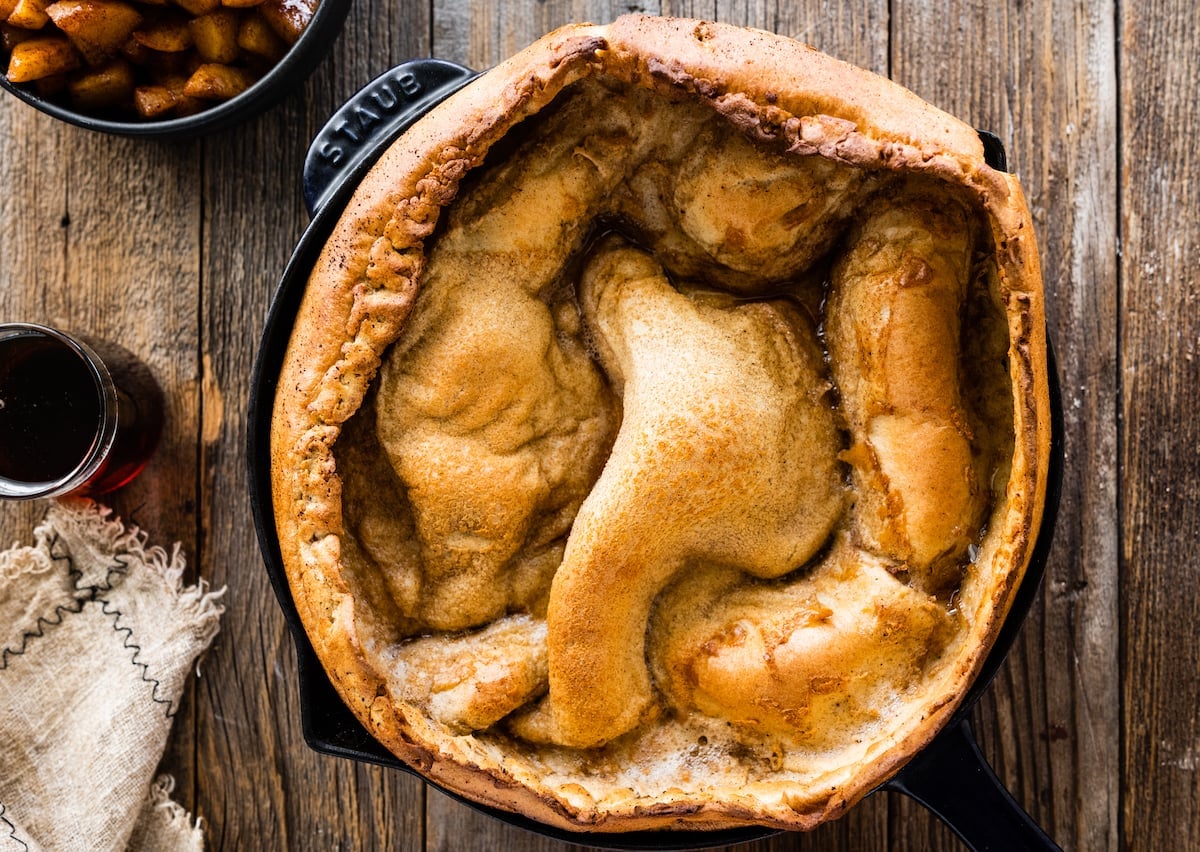 brown butter Dutch baby pancake puffed in cast iron skillet.