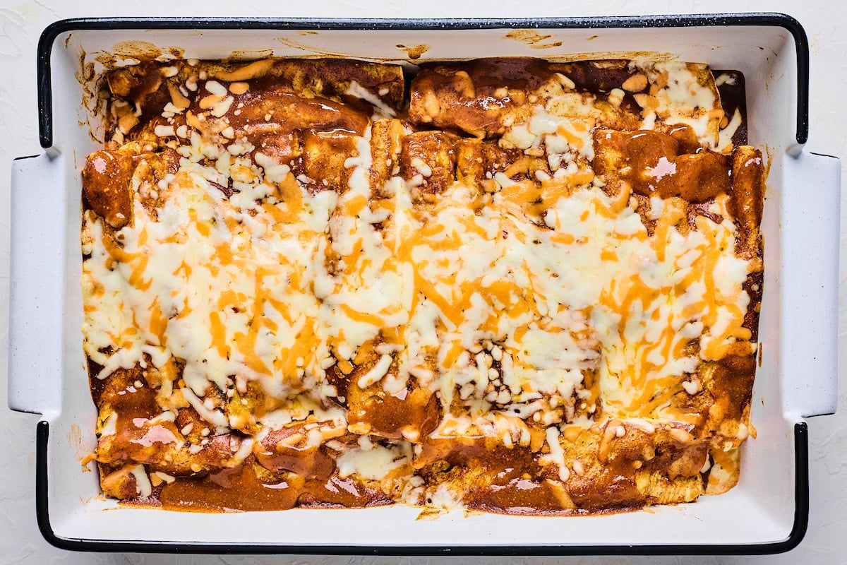 cauliflower enchiladas in pan with melted cheese.