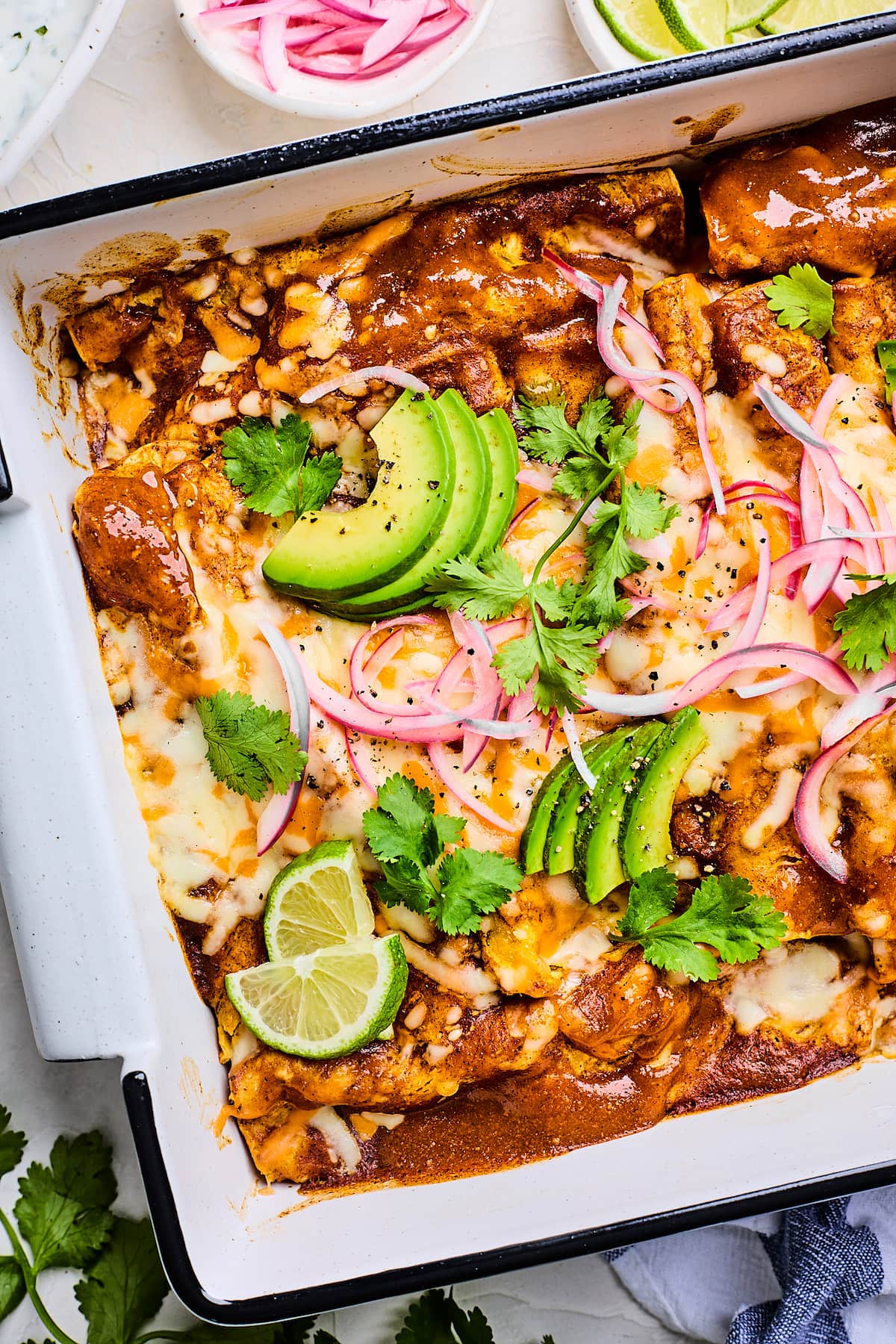 close up of cauliflower enchiladas in baking dish.