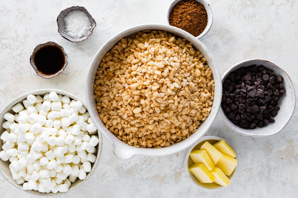 ingredients in bowls to make chocolate rice krispie treats.