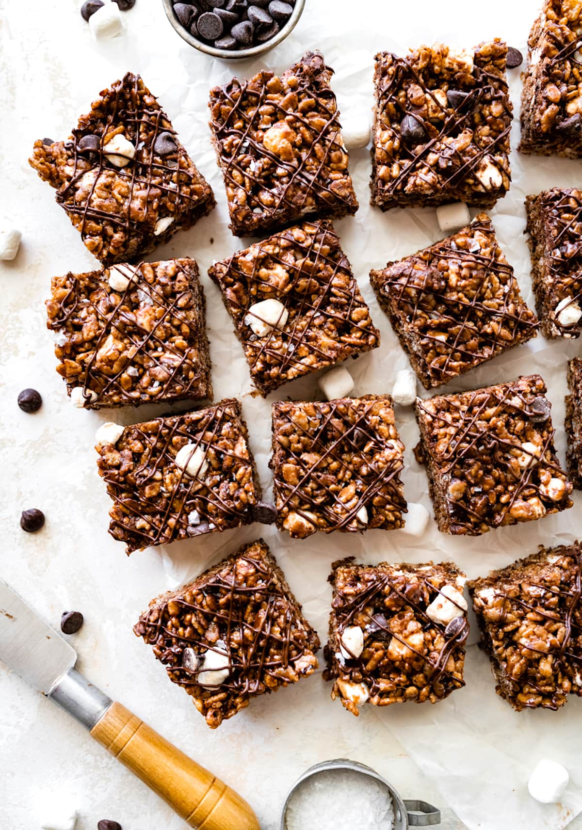 chocolate rice krispie treats cut into squares with chocolate drizzle.