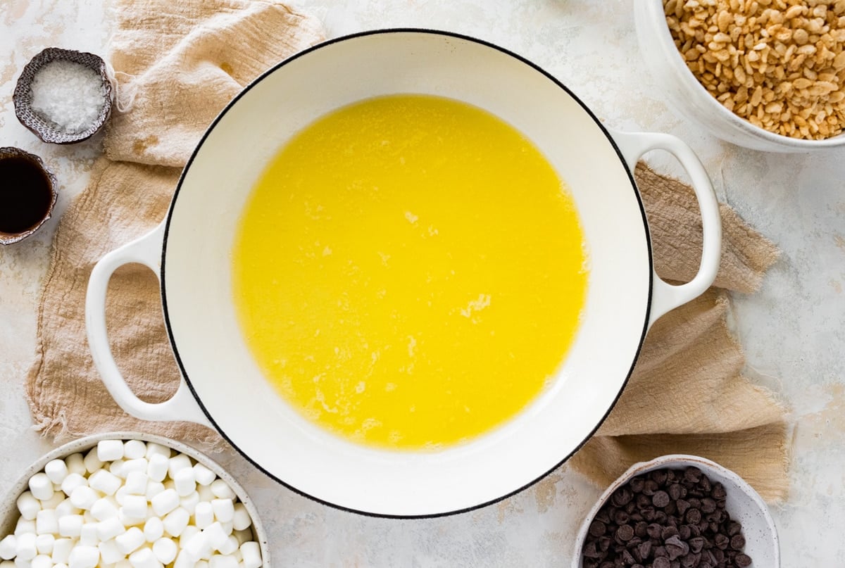 melted butter in large white pot to make chocolate rice krispie treats.
