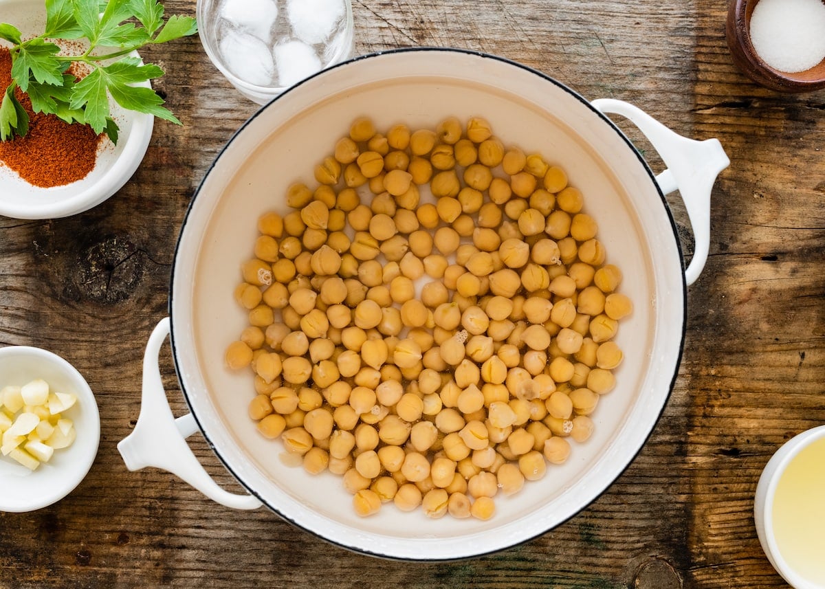 chickpeas in white pot with water to make hummus.