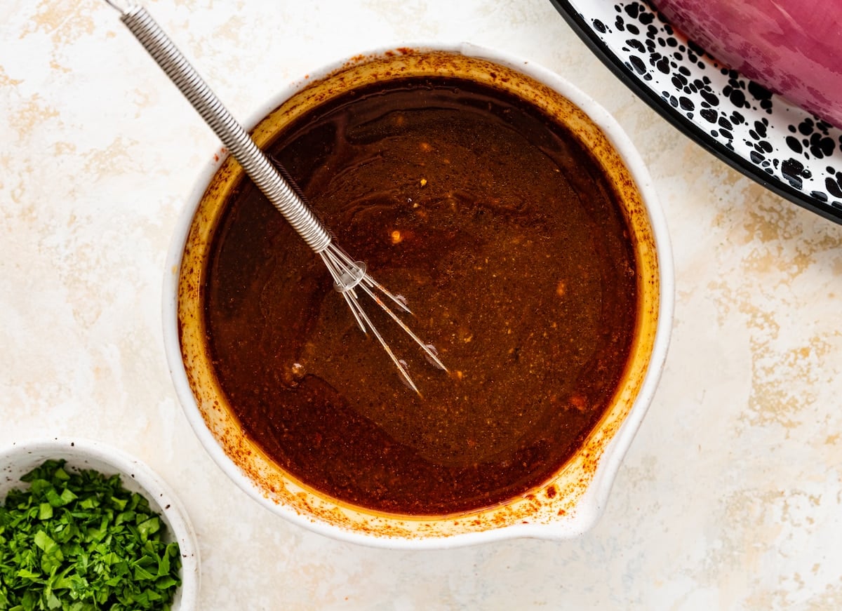 pork tenderloin marinade in bowl with whisk.