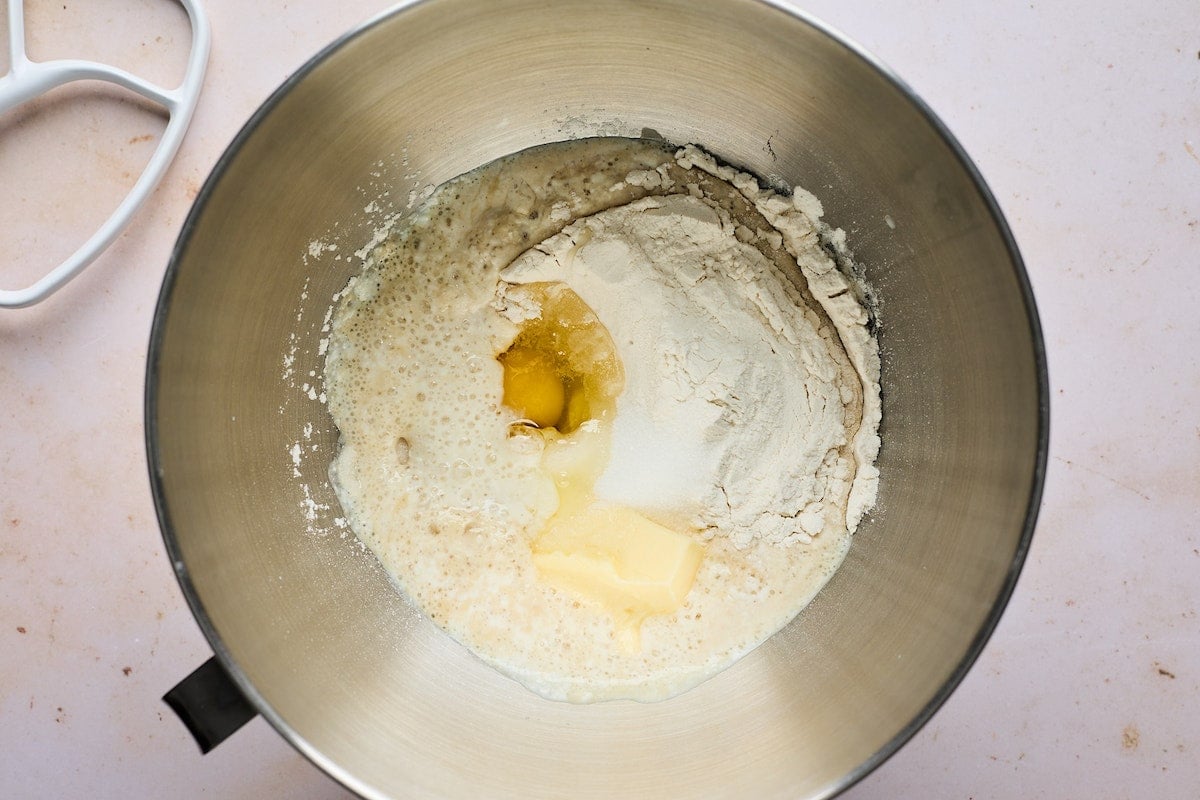 flour, eggs, butter, yeast, and buttermilk in mixing bowl.