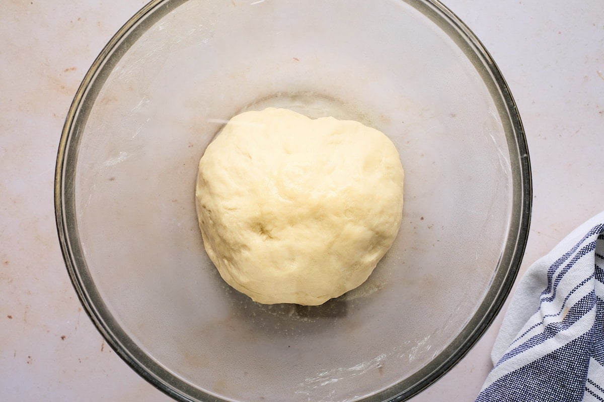dinner roll dough in bowl waiting to rise.