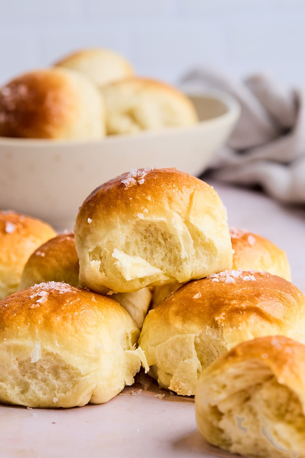 flaky dinner rolls stacked with butter and sea salt.