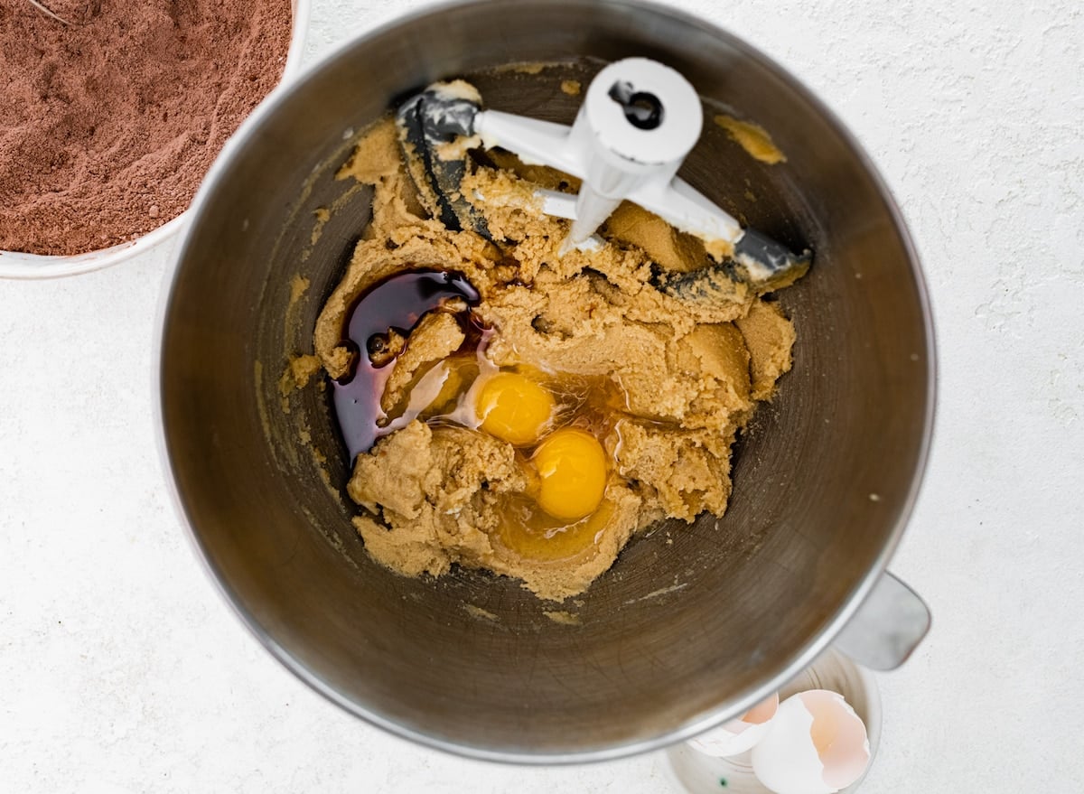 creamed butter and sugars in mixing bowl with eggs and vanilla extract.