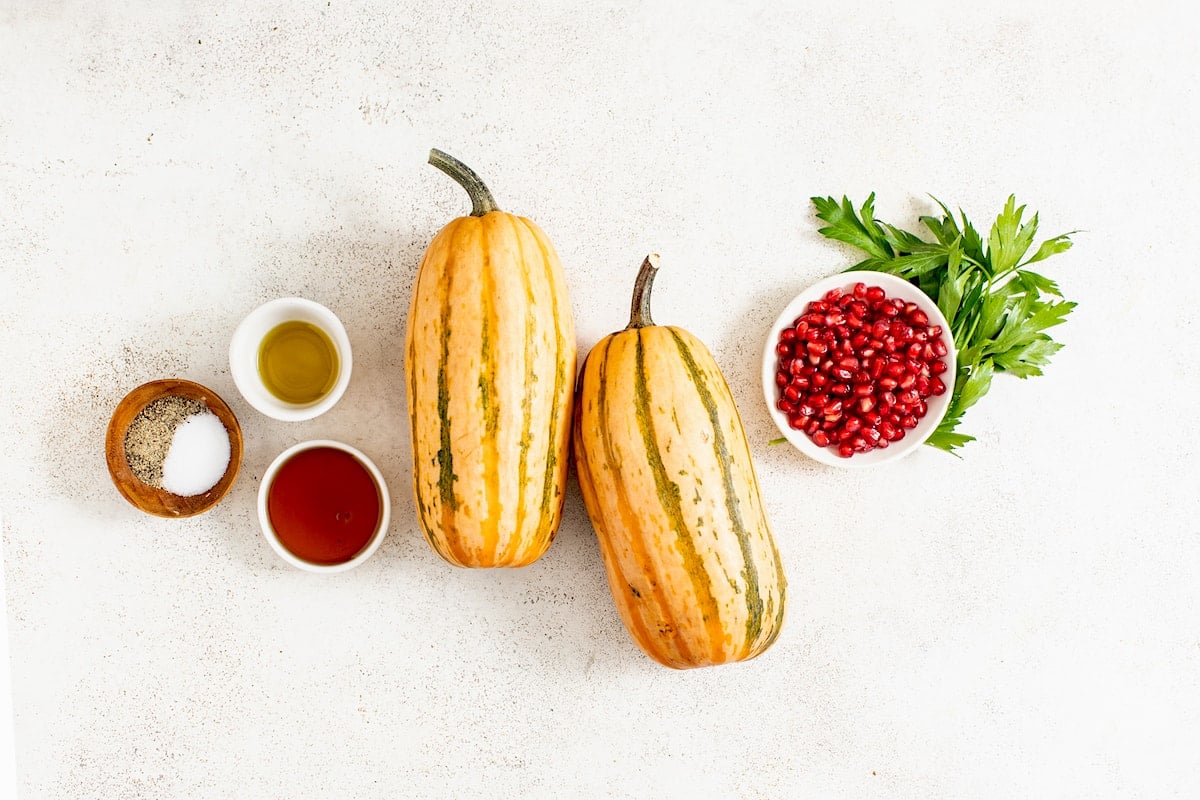delicata squash, salt, pepper, olive oil, maple syrup, pomegranate, and parsley.