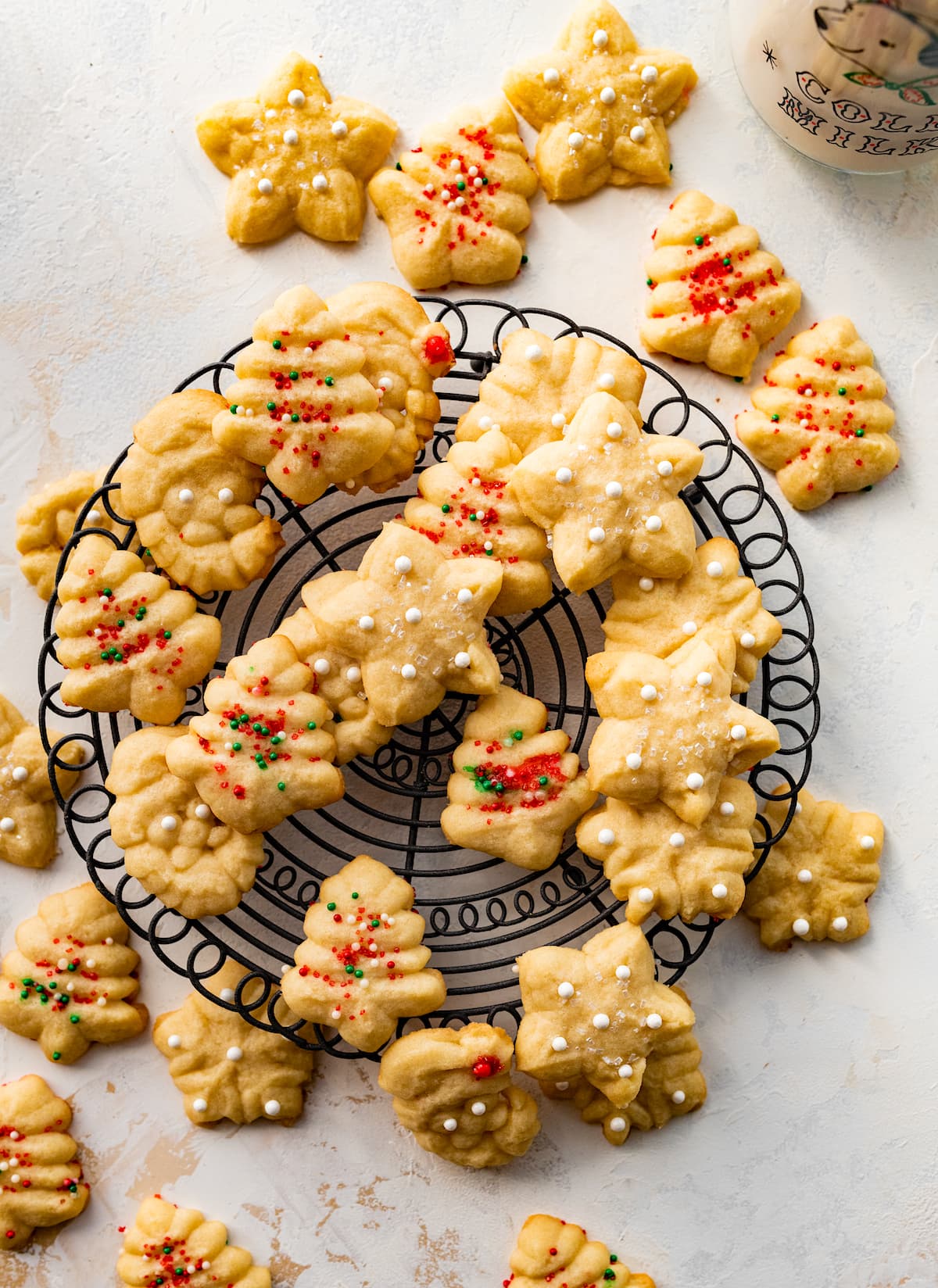 spritz cookies with sprinkles on cooling rack.