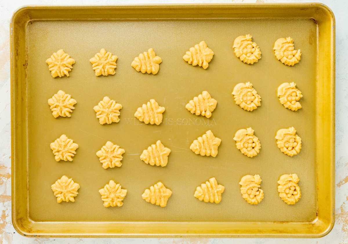 spritz cookies on baking sheet.