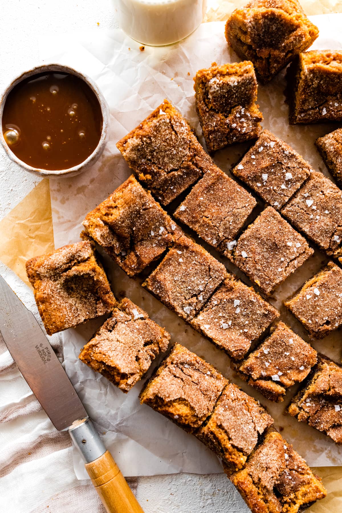 brown butter salted caramel snickerdoodle blondies cut into squares.