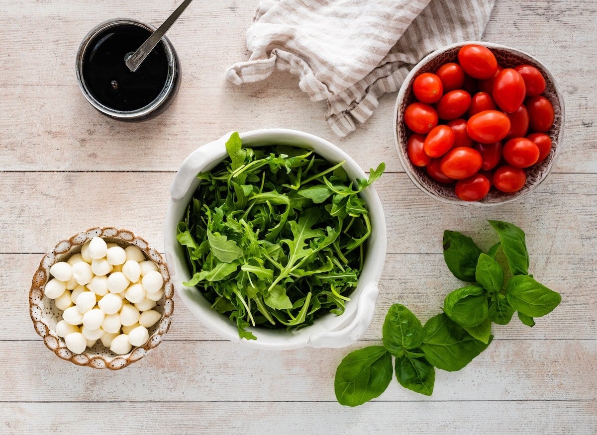 ingredients in bowls to make caprese wreath salad.