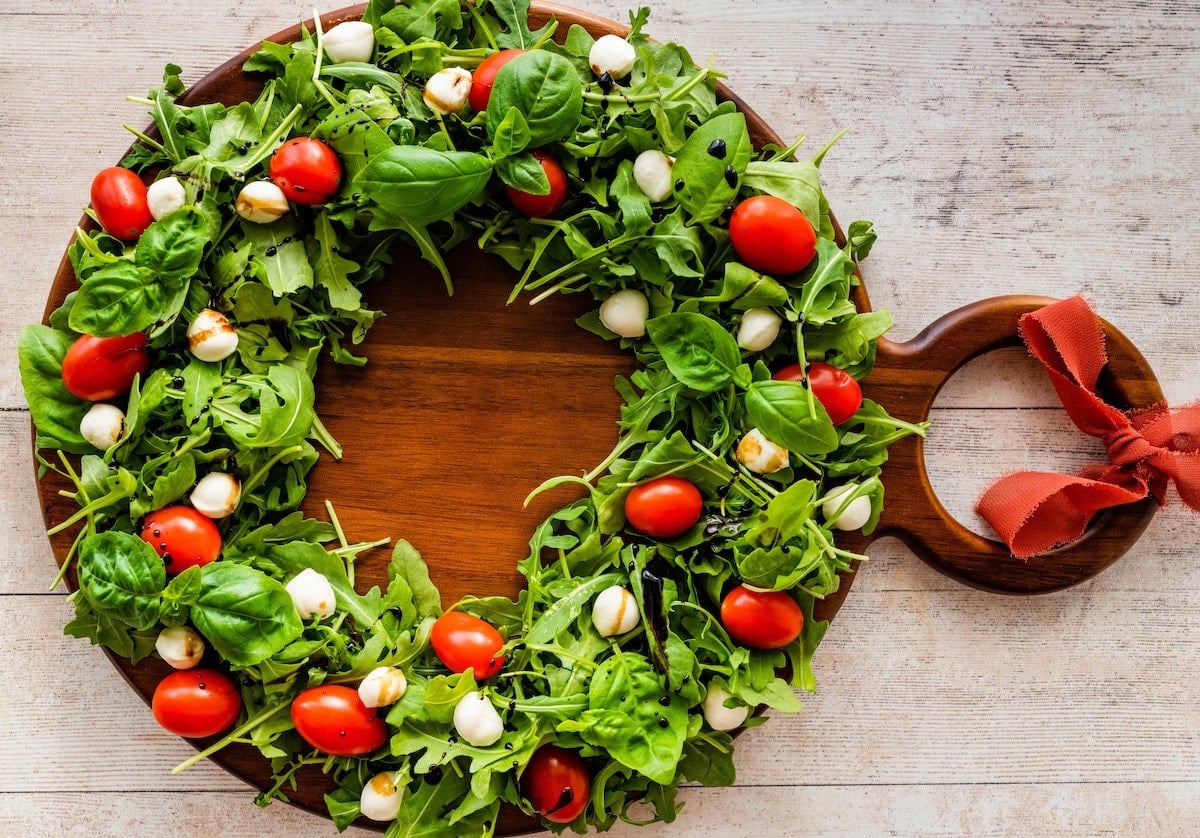 caprese wreath salad on wood board.