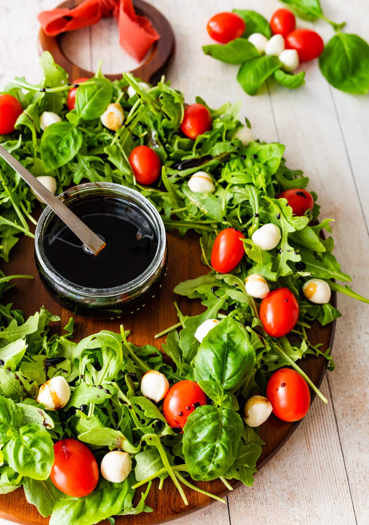 wreath salad with arugula, tomatoes, fresh mozzarella, and balsamic vinaigrette.