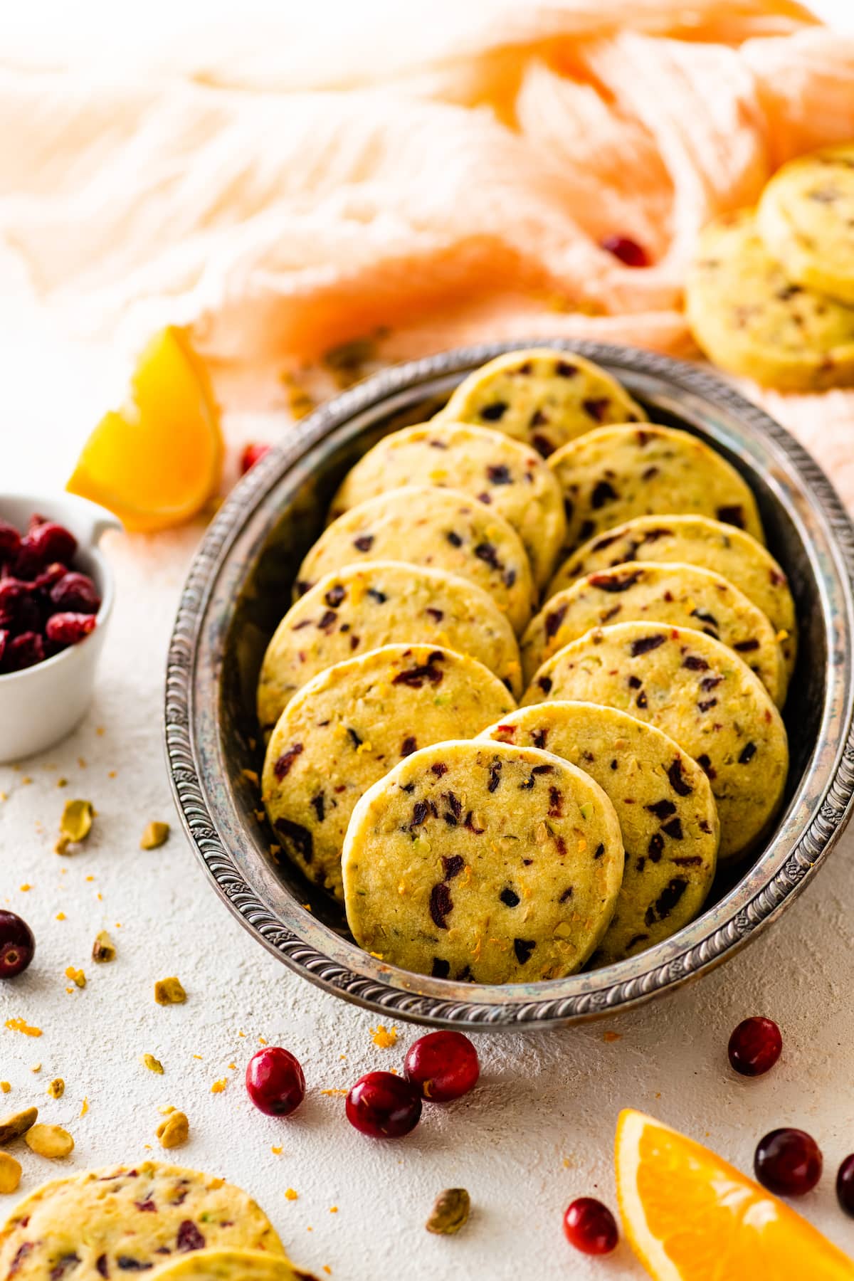cranberry orange pistachio shortbread cookies in sliver serving platter.