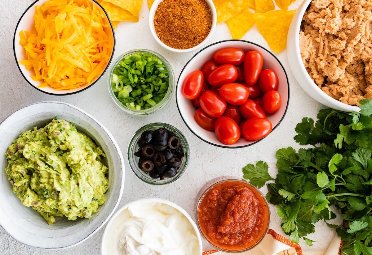 7 layer dip ingredients in bowls.