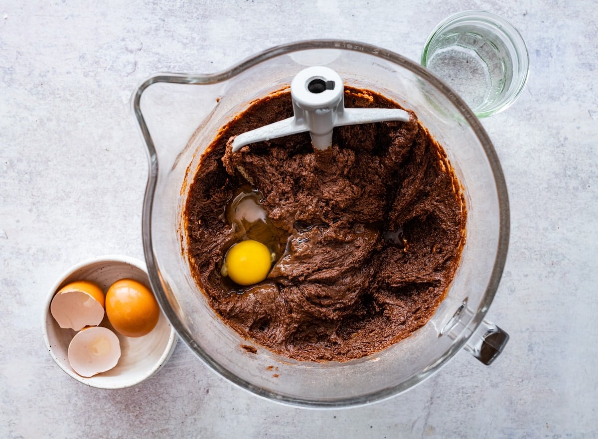 chocolate cake batter in mixing bowl with beater blade.