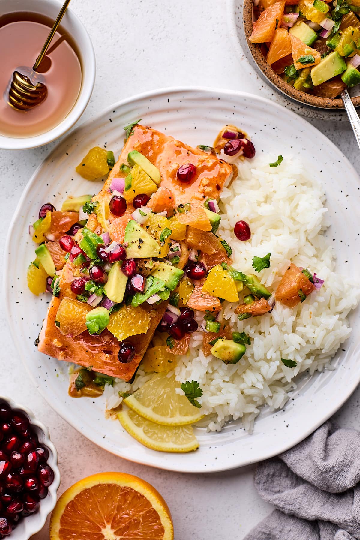 honey mustard salmon with citrus salsa on plate with rice.
