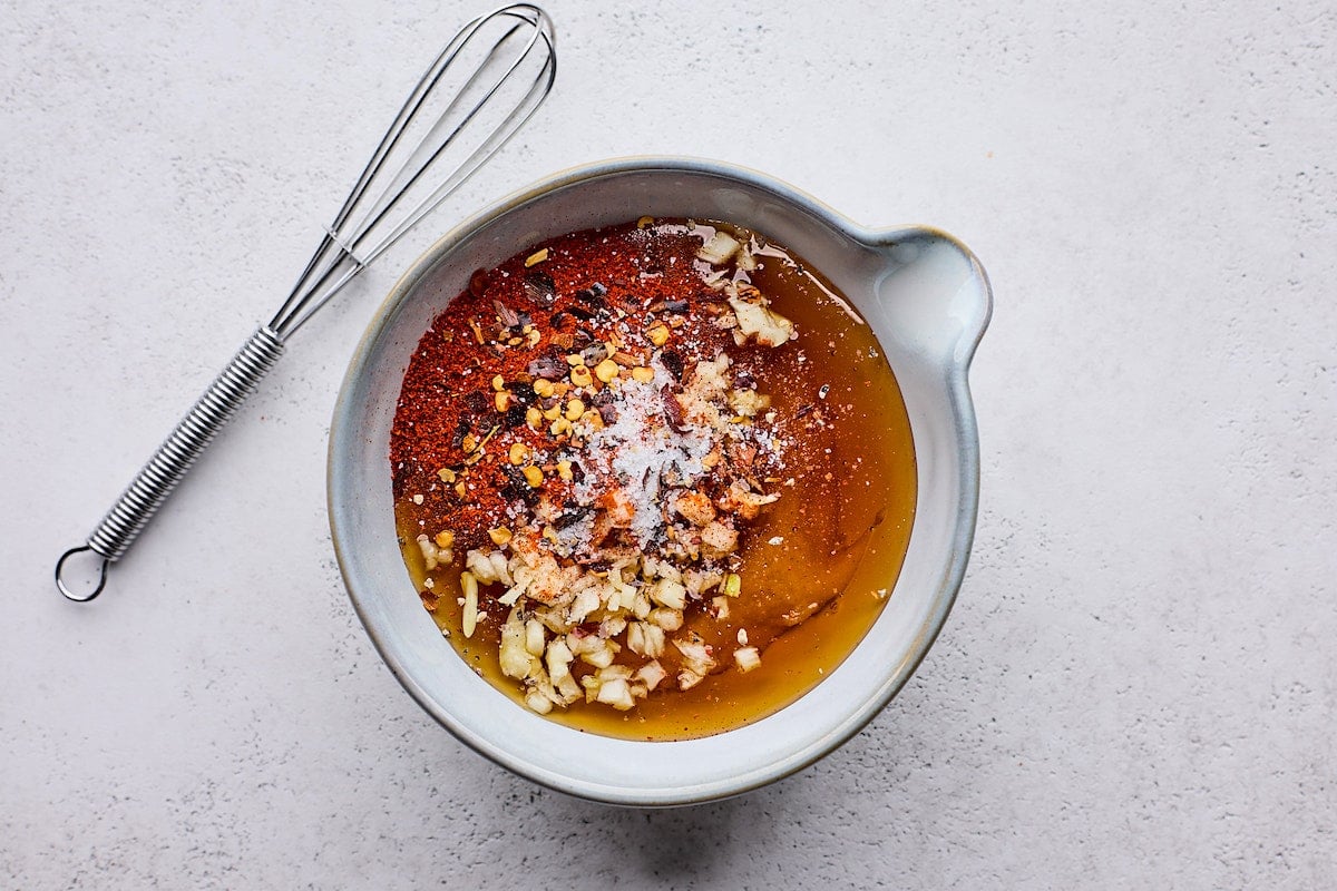 honey mustard ingredients in mixing bowl with whisk.