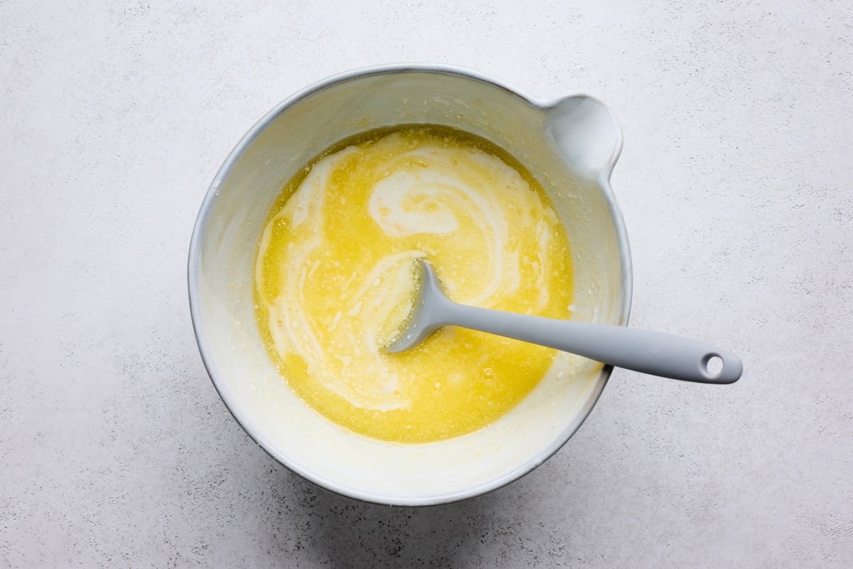 melted butter and buttermilk in mixing bowl with spatula.