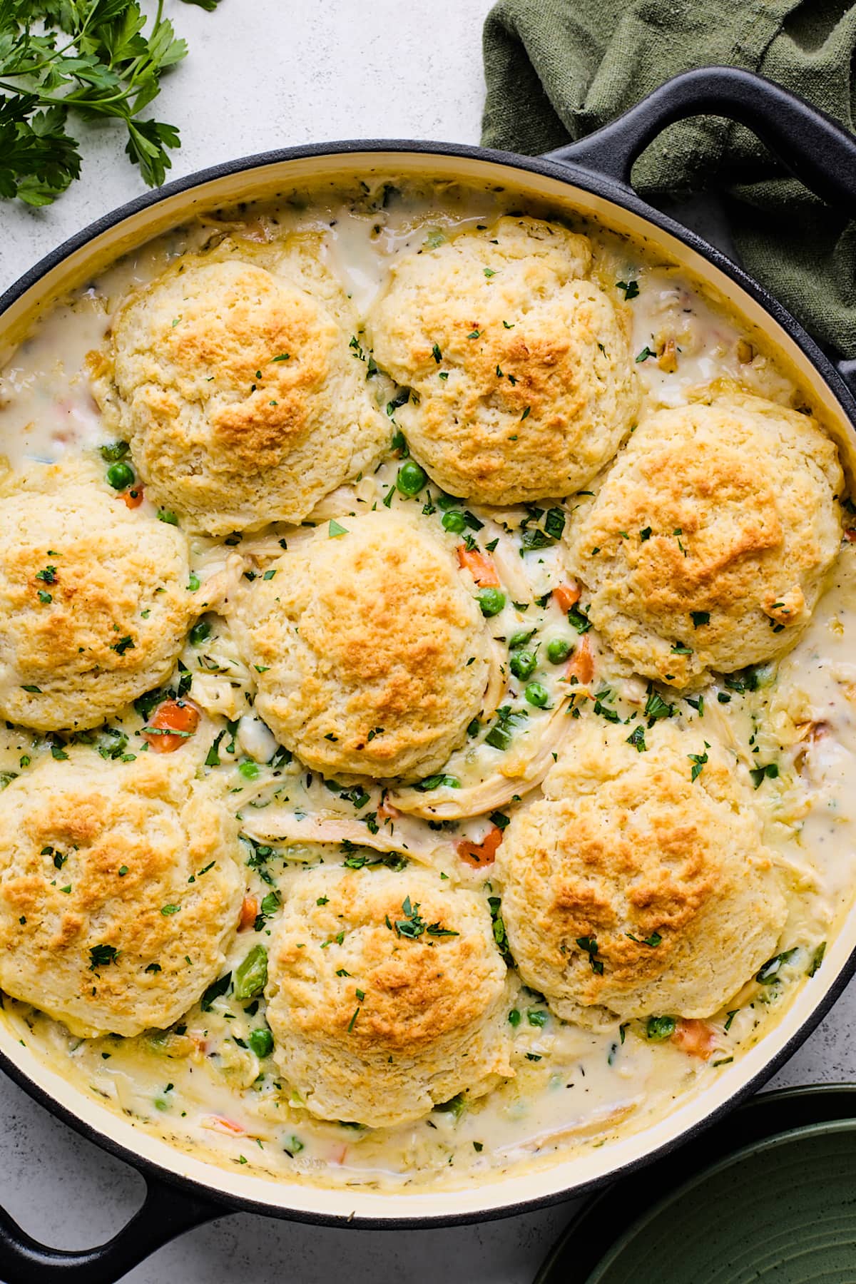 chicken pot pie with biscuits in skillet.