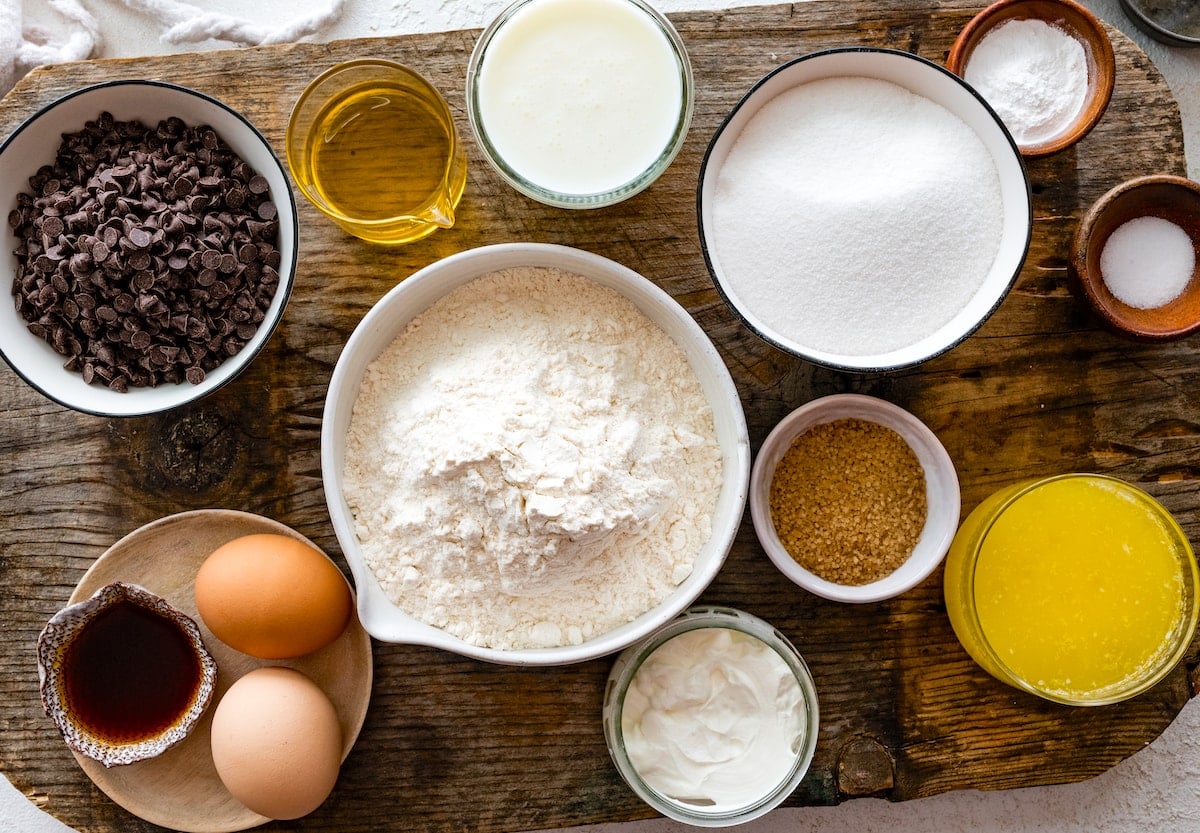 ingredients in bowls to make chocolate chip muffins.