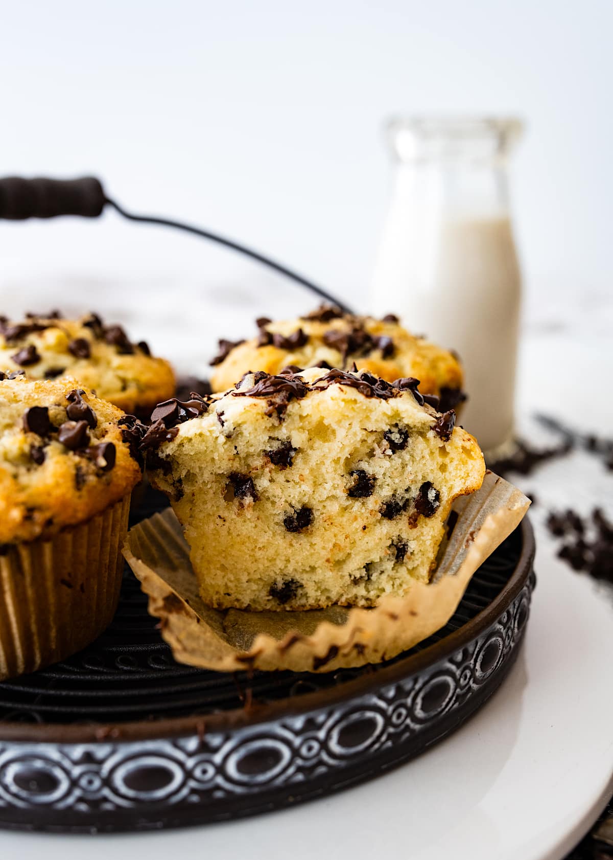 chocolate chip muffin cut in half in muffin paper liner.