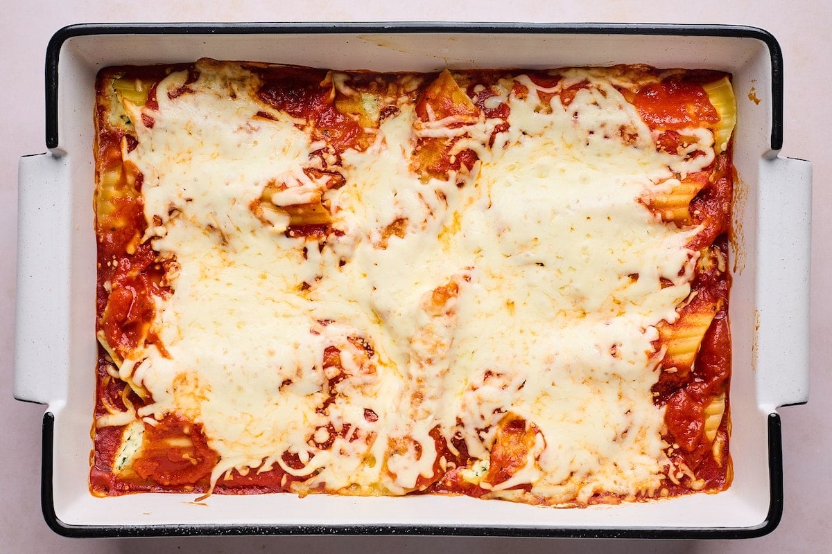 baked manicotti with mozzarella cheese in baking dish.