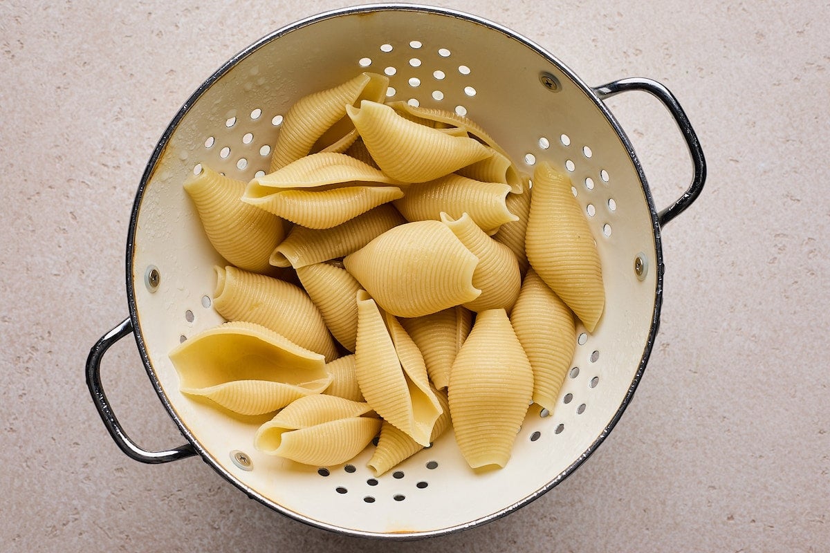 cooked jumbo shells in colander to make stuffed shells.