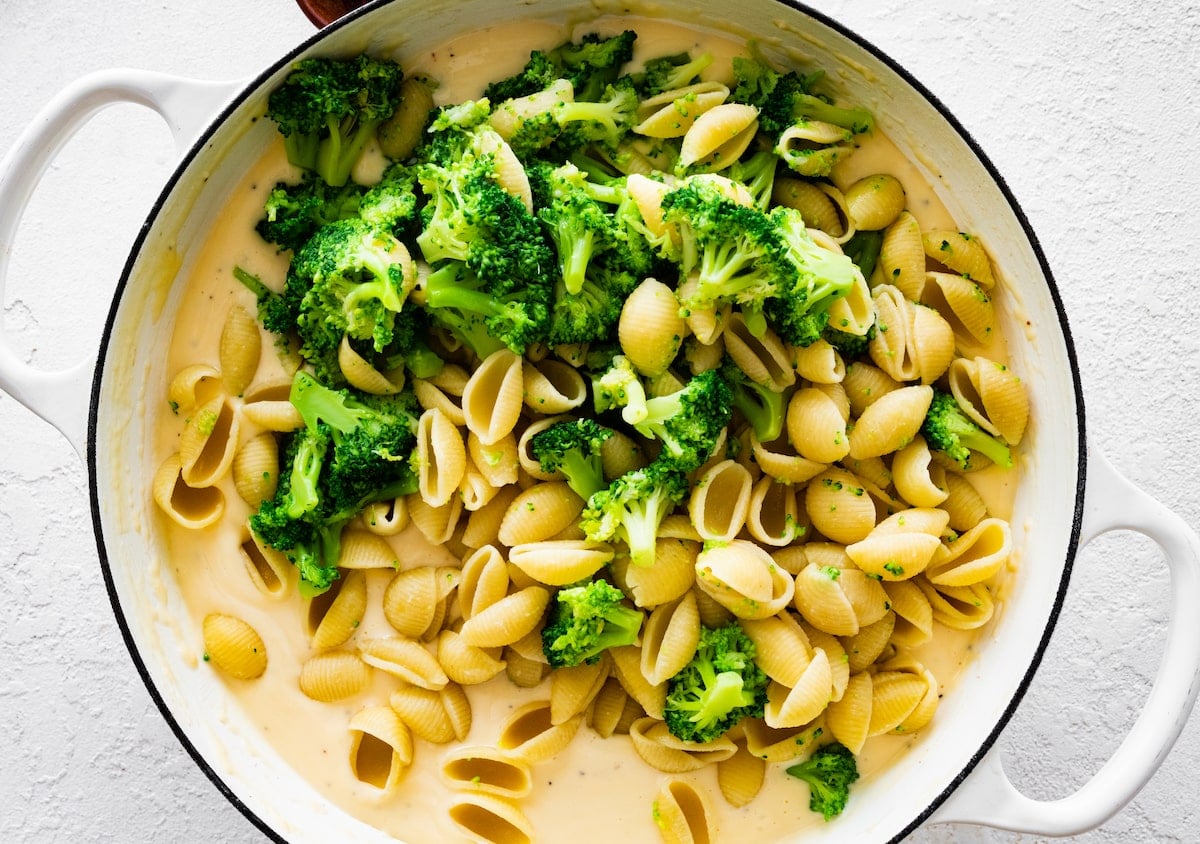 broccoli mac and cheese in white pot.