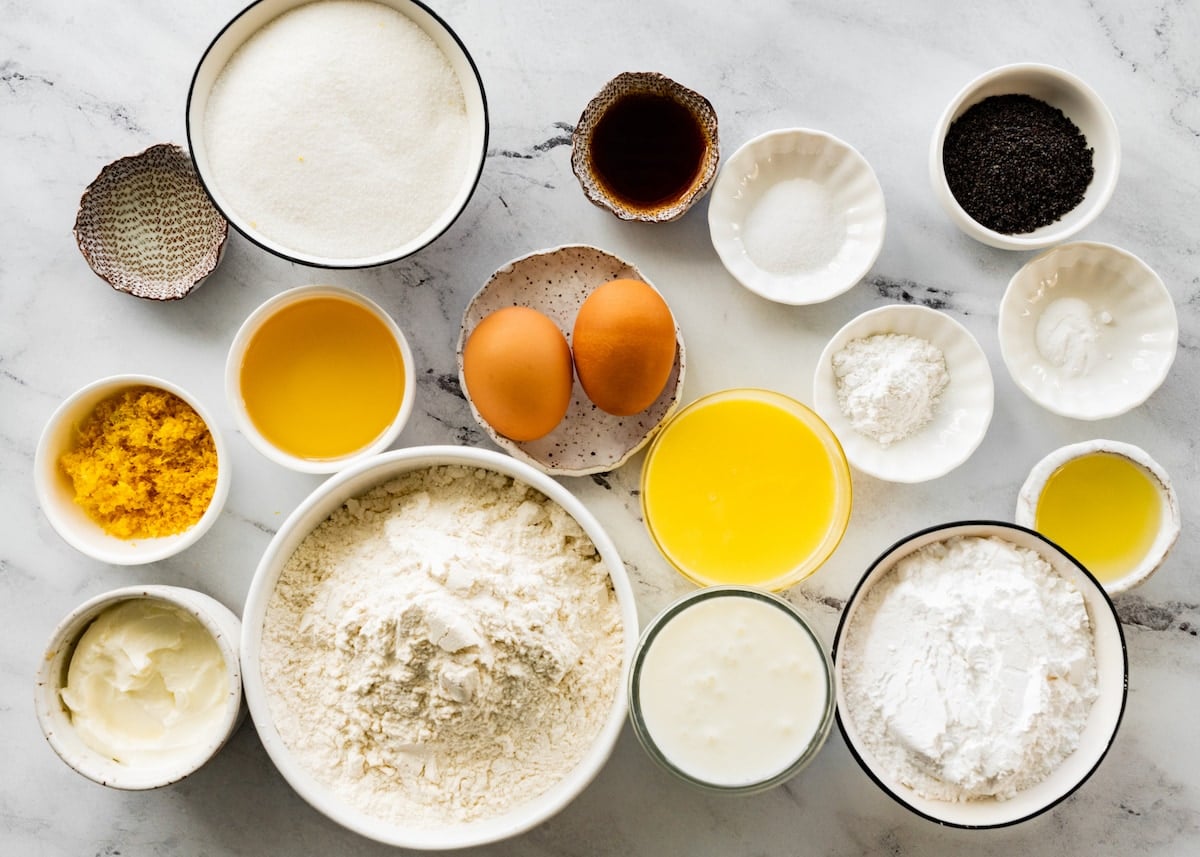 ingredients in bowls to make lemon poppy seed muffins.