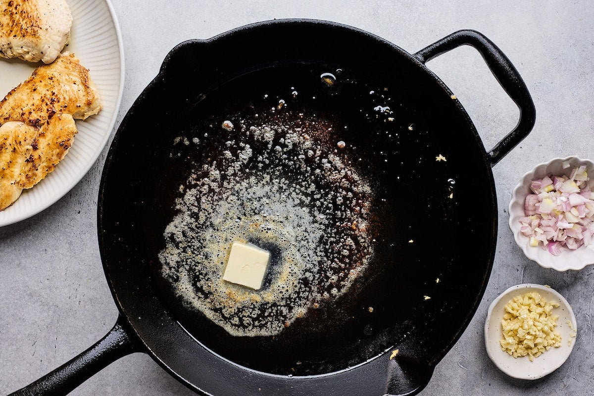 butter melting in cast iron skillet.