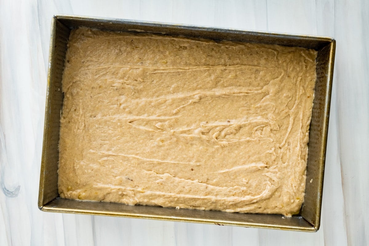 banana cake batter in rectangle cake pan.