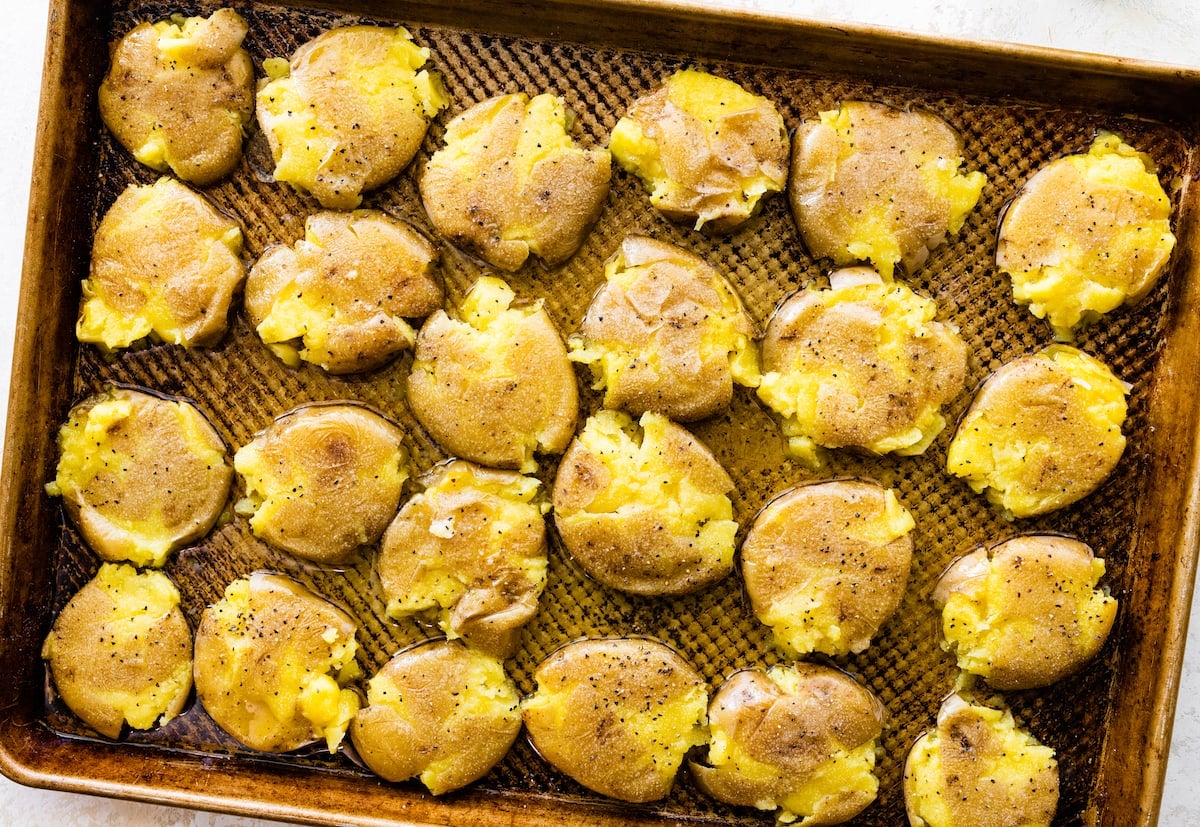 smashed potatoes on baking sheet.