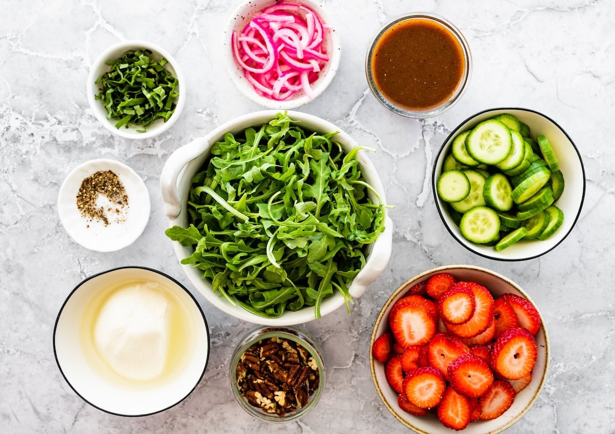 ingredients for strawberry burrata salad in bowls.