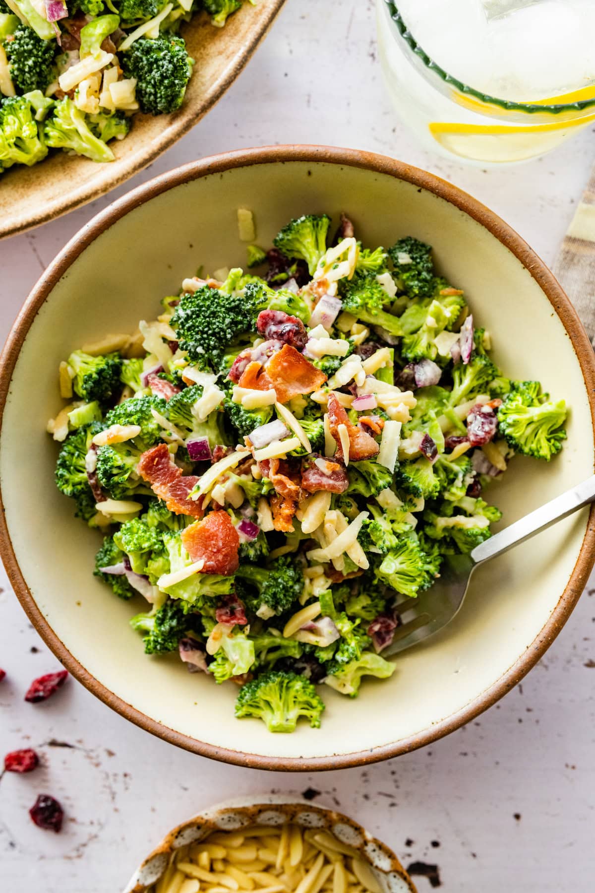 broccoli salad in bowl with fork.