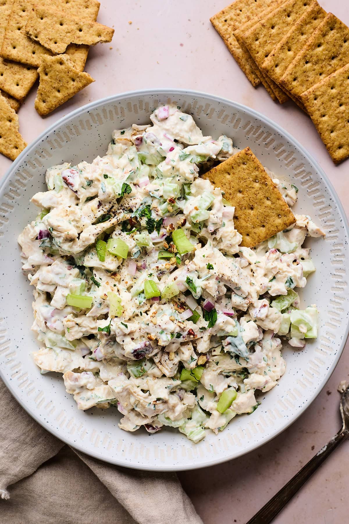 chicken salad in bowl with crackers.