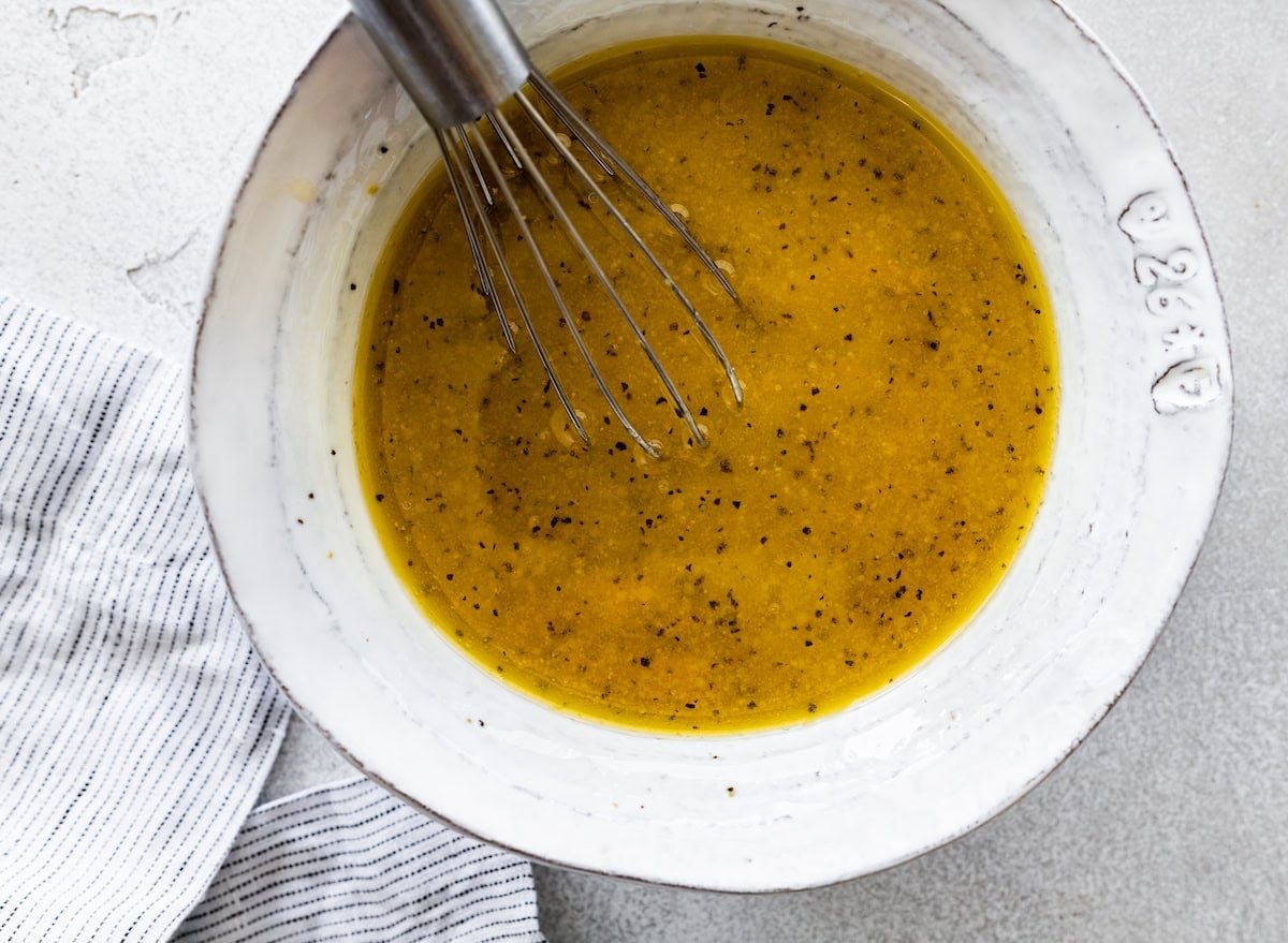 lemon vinaigrette in bowl with whisk.