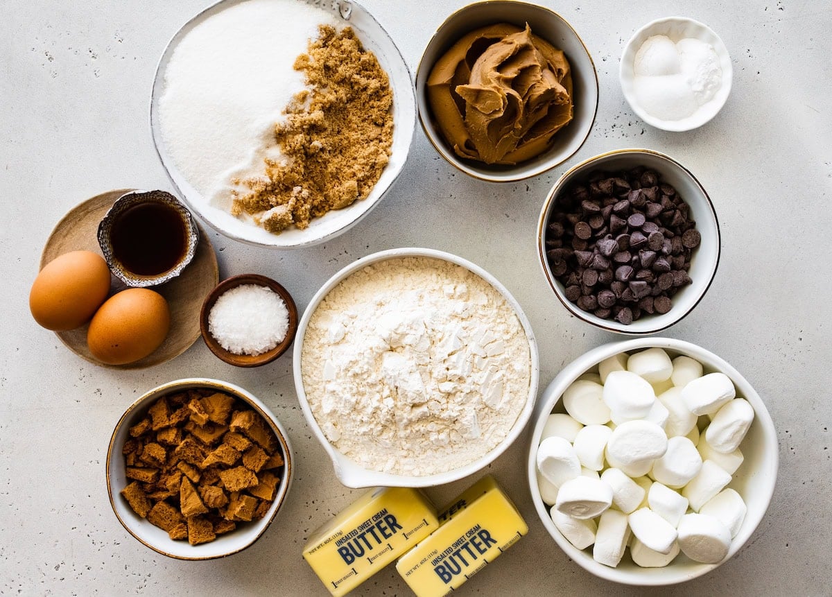 ingredients in bowls to make biscoff s'mores cookies.