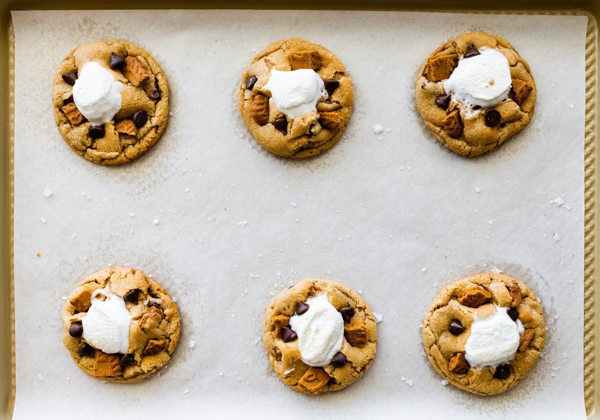 Biscoff s'mores cookies on baking sheet with parchment paper.