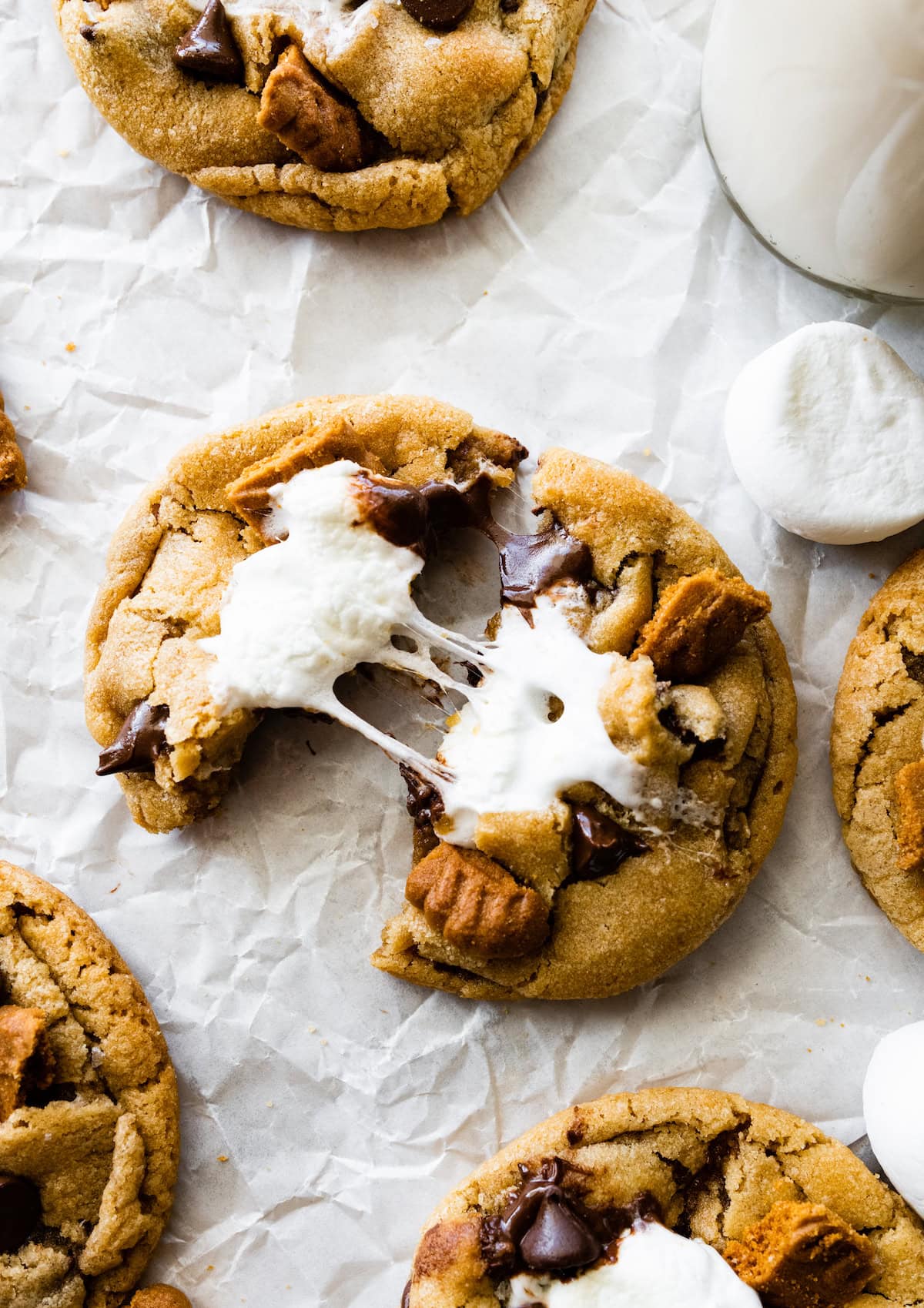 Biscoff s'mores cookie broken in half with gooey marshmallow.